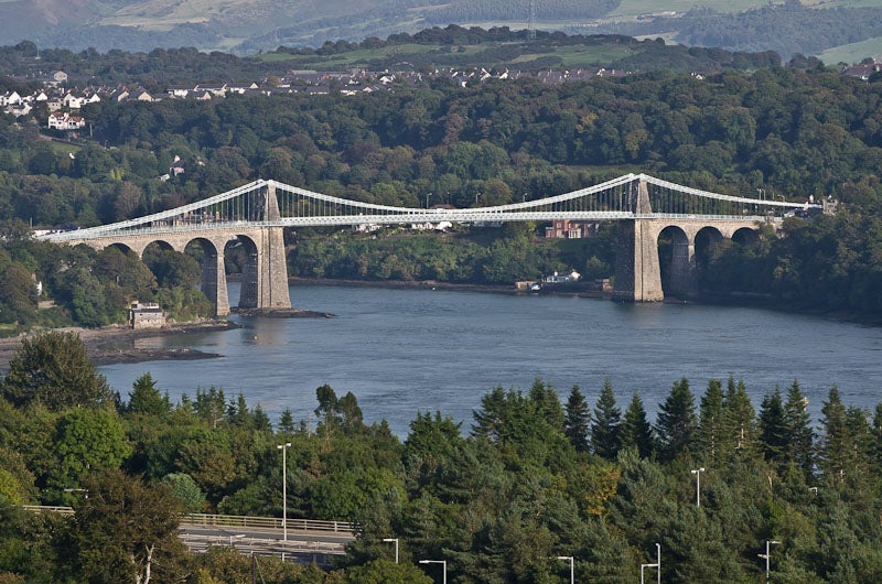 The Menai Suspension Bridge, with Anglesey at the left and Bangor, Wales, on the right, recent photograph by Ian Capper (Wikimedia commons)