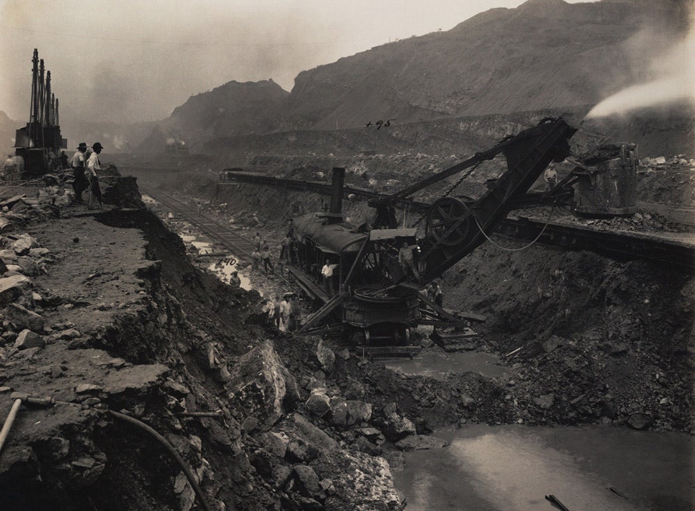 Workers gather around steam shovel #222 after completing bottom pioneer cut in Culebra Cut, May 20, 1913.
 After years of digging and blasting through the continental divide, steam shovels #222 and #230 finally faced one another on the bottom of the Cut, at 40 feet above sea level.  View in Digital Collection »