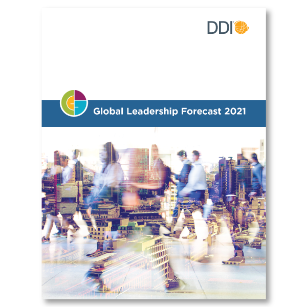 front cover of DDI's Global Leadership Forecast 2021 report, DDI logo in the corner, with a busy city scene as the bottom image with business professionals seen rushing around with the city scene ?auto=format&q=75