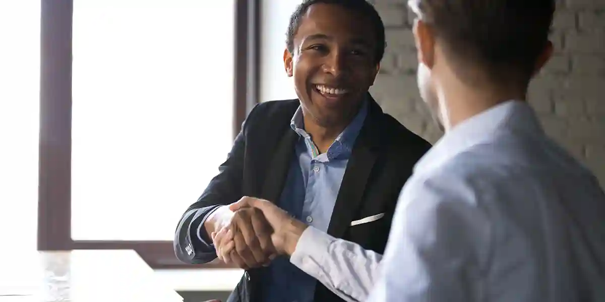 Men shaking hands, exhibiting inclusive leadership