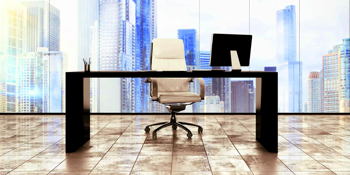 a desk in an executive office with city skyline in the background