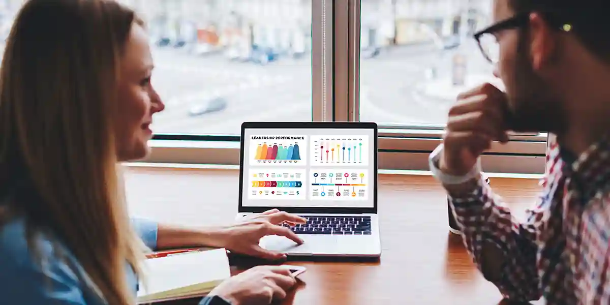 Man and woman at computer using and Interpreting Talent Benchmarks 