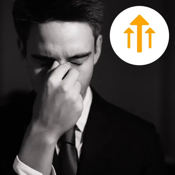 Man holding nose in frustration?fm=webp&q=75