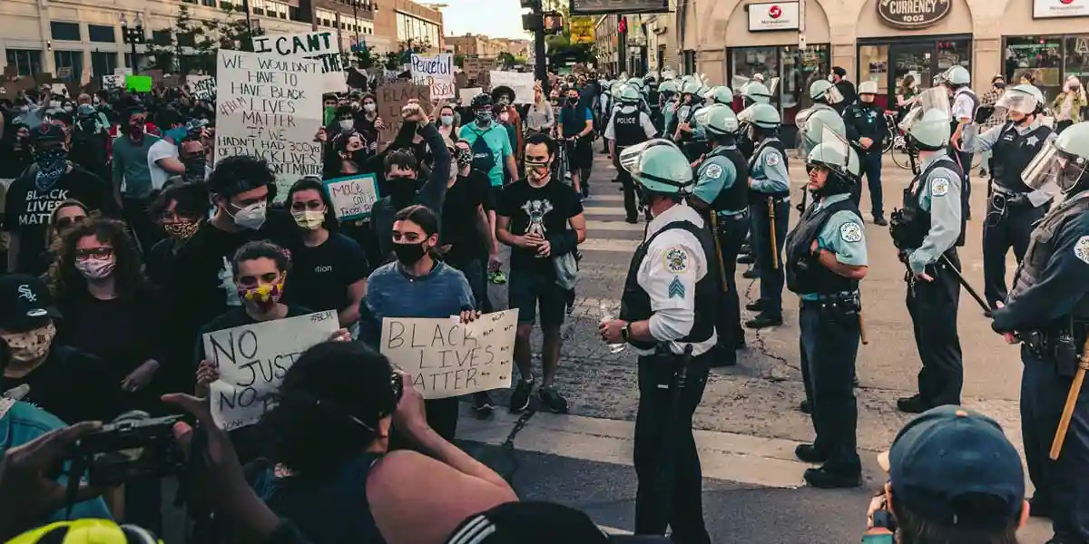 Protesters look at police on a street