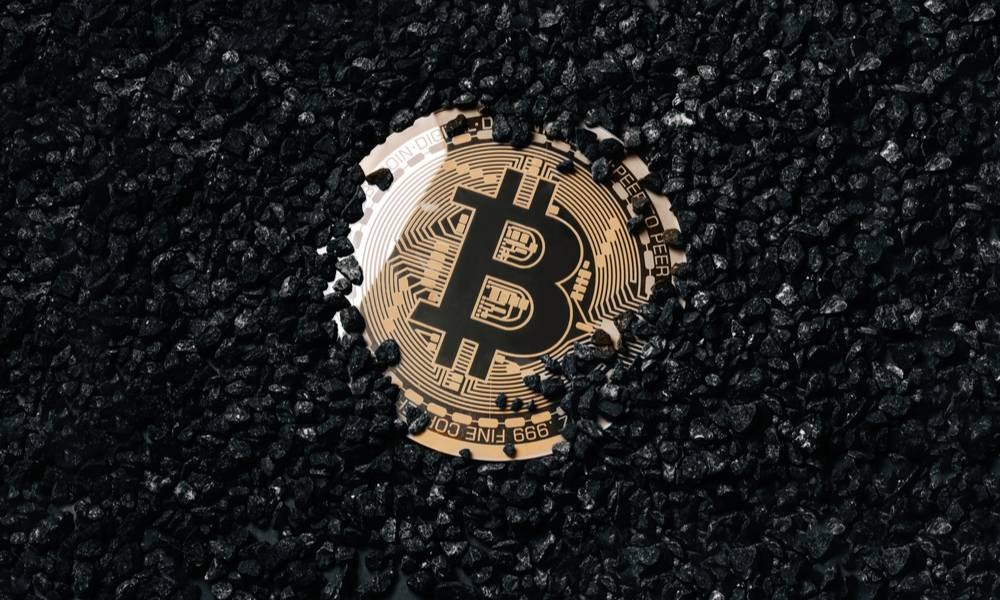 A bitcoin drowning in coals to show environmental impact of blockchain digital currency.jpeg