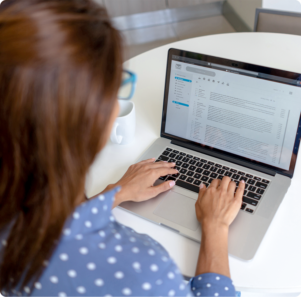 A woman verifying her email on a laptop