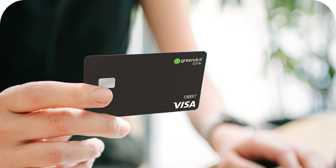 Green Dot® Visa® Debit Card Holding up Green Dot® Visa® Debit Card received at CheckSmart.
