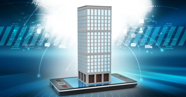 A cell phone displaying a tall building on its screen, showcasing urban architecture and technology integration.