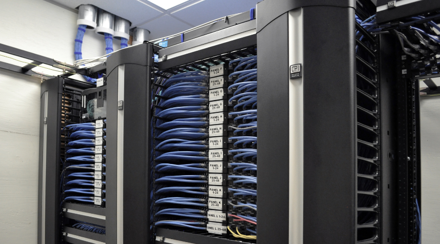 Data center infrastructure with blue network cables in server racks.