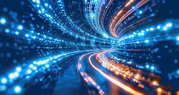 Abstract image of swirling blue and orange light trails on a dark background.