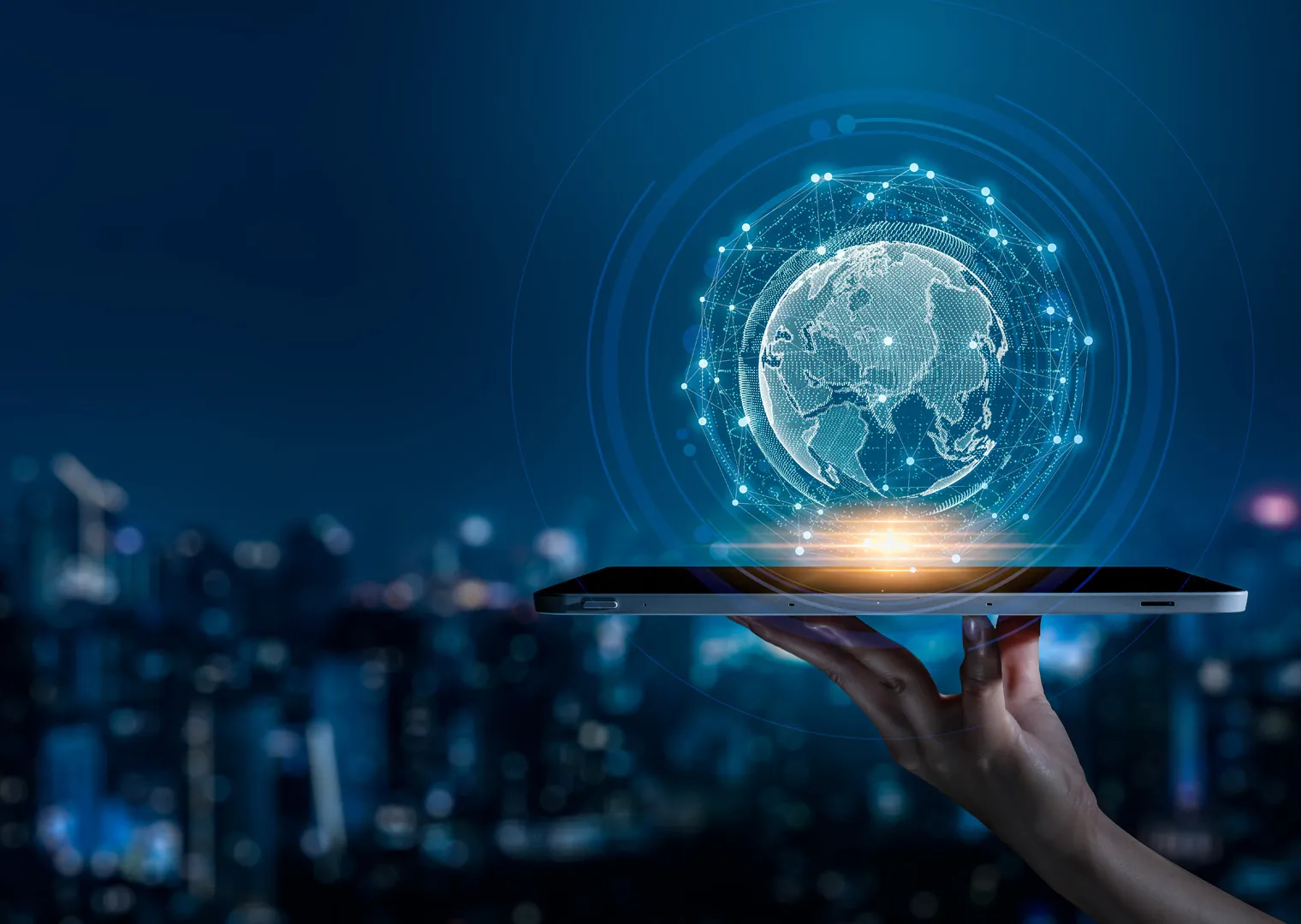 A hand holding a tablet displaying a digital globe with network connections.