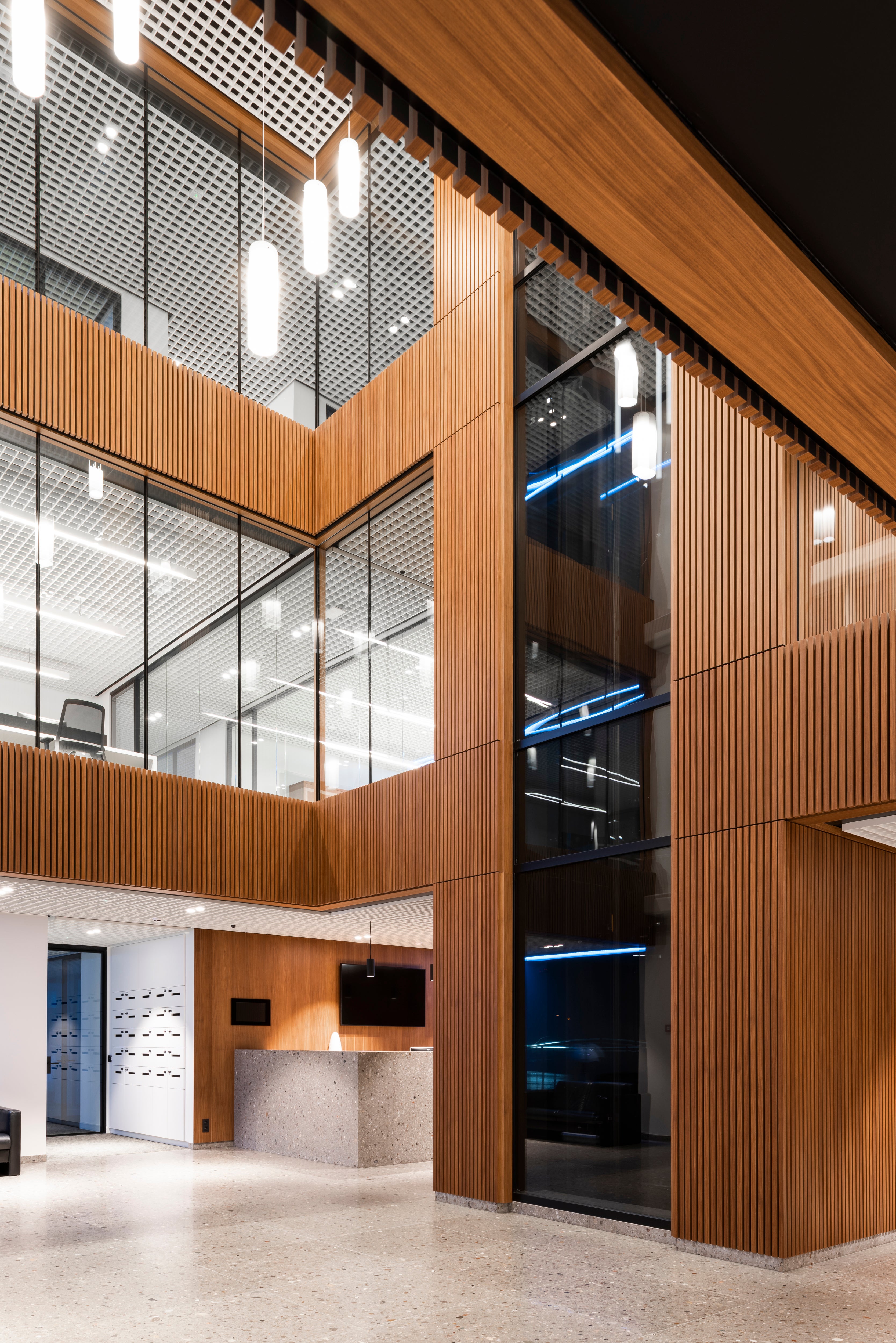 inside of an office building with wood veneer paneling and glass windows