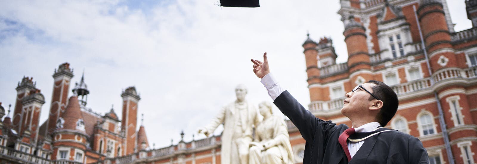Graduate throwing cap in the air
