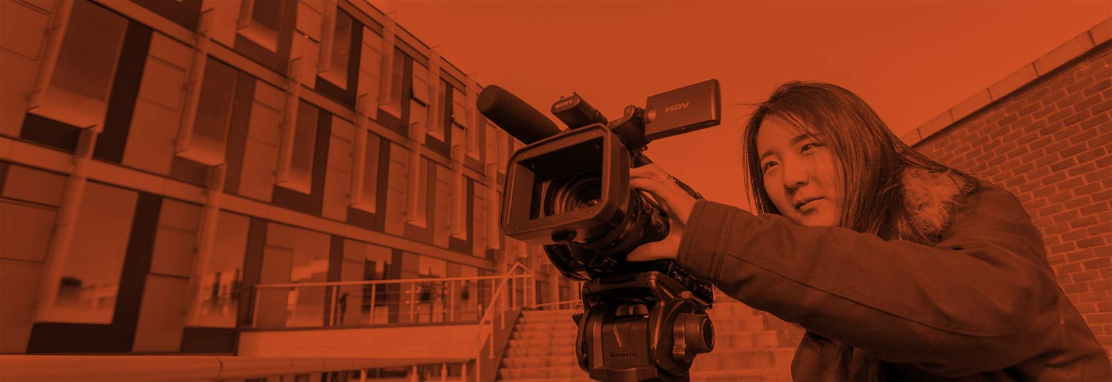 A University of Sussex student filming on campus