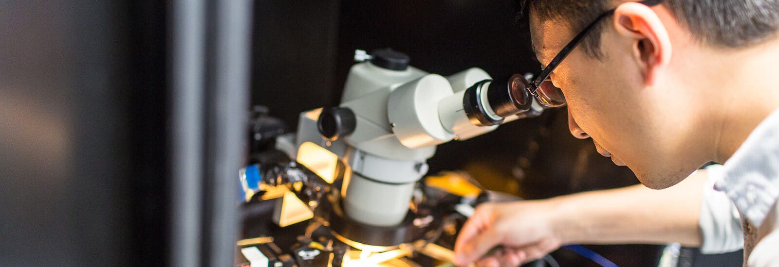 A student using a microscope.