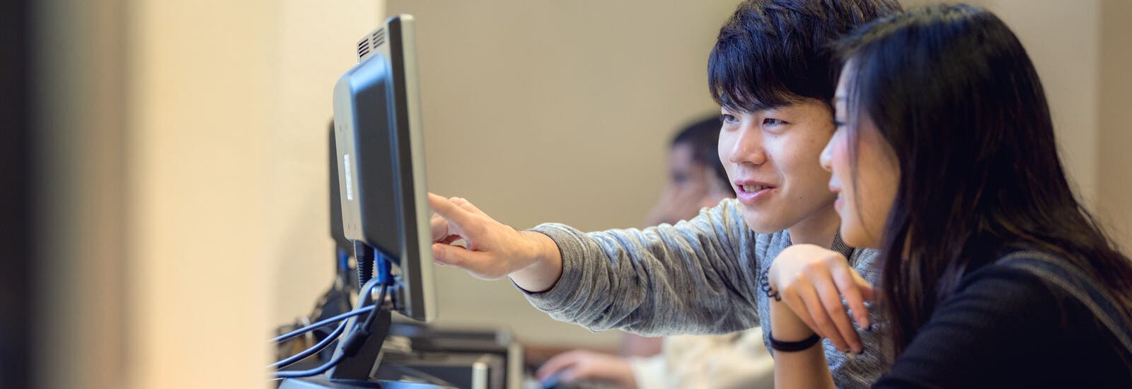Two students looking at a computer