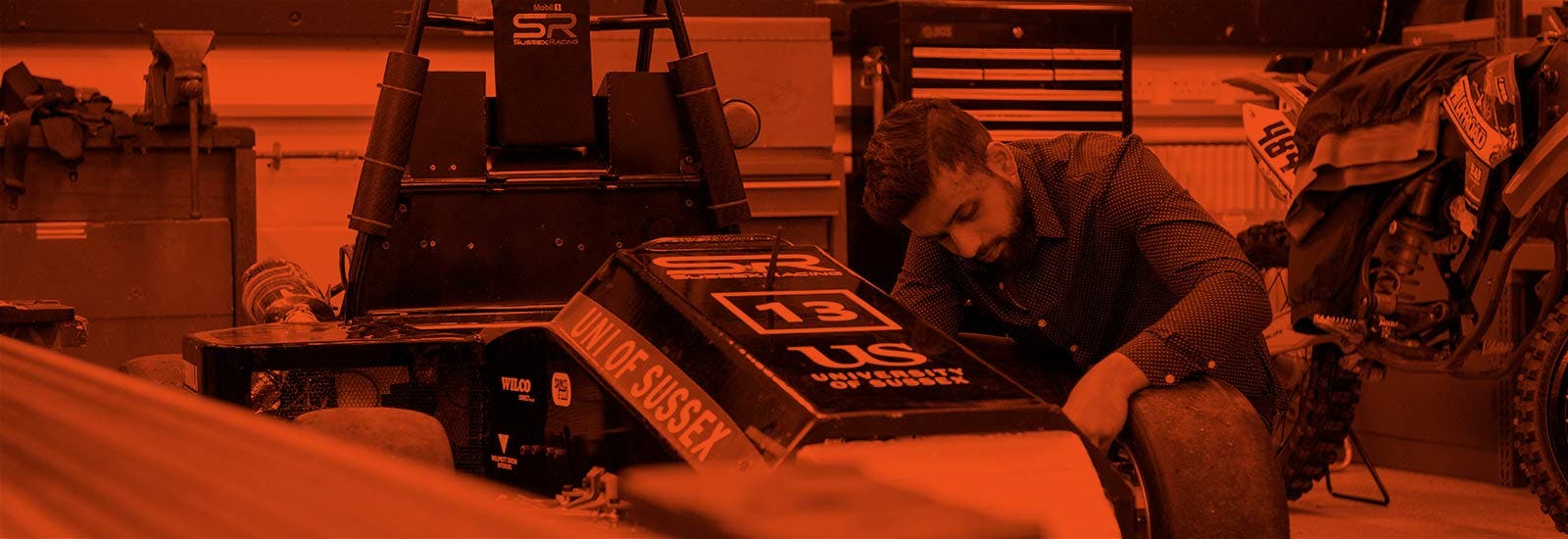 A University of Sussex student working on a race car