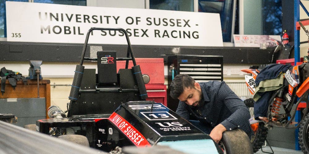 Student working on racing car