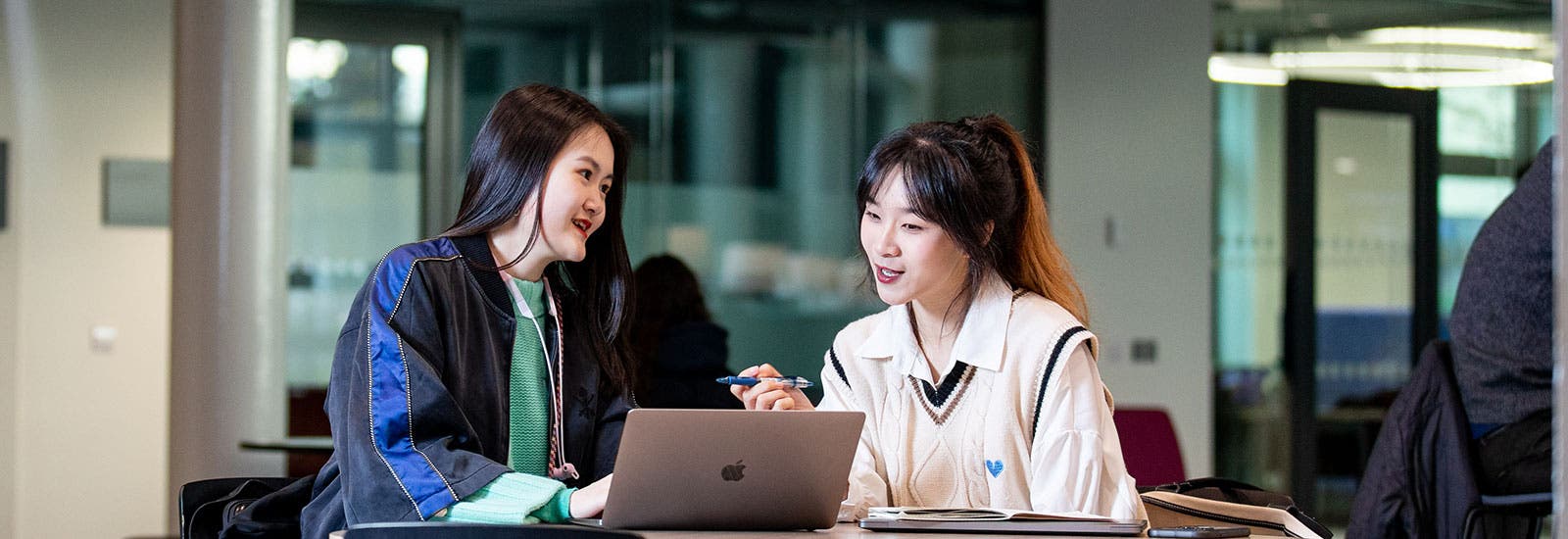 Students studying together with a laptop