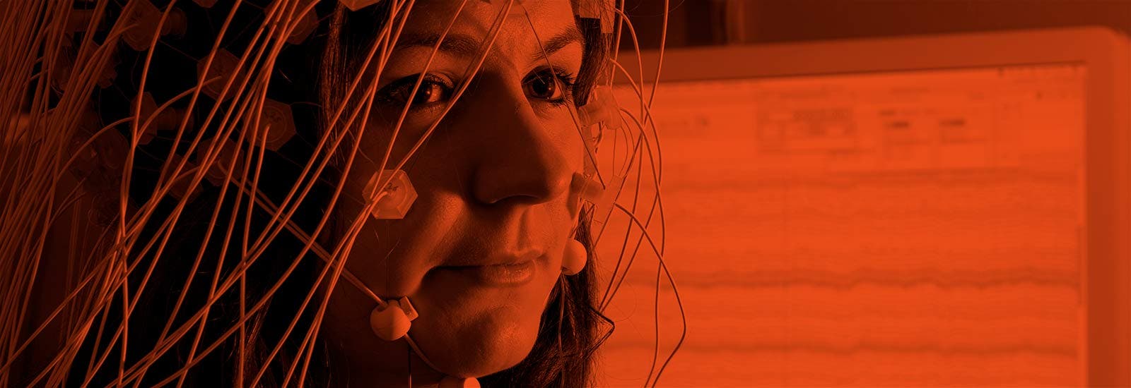 A woman plugged into a brain activity monitoring device