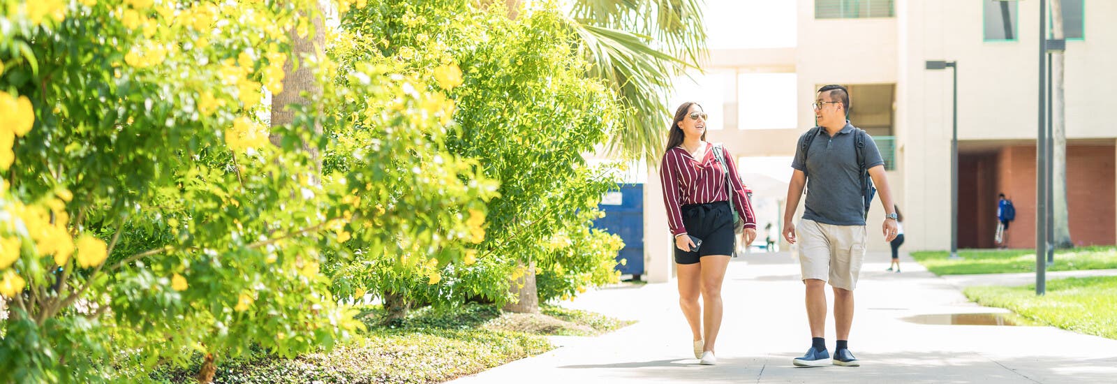 Two students walking together outside campus