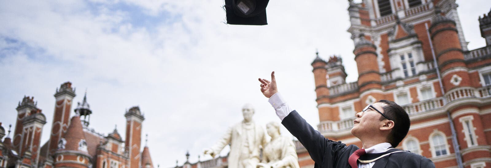Graduate throwing cap in air