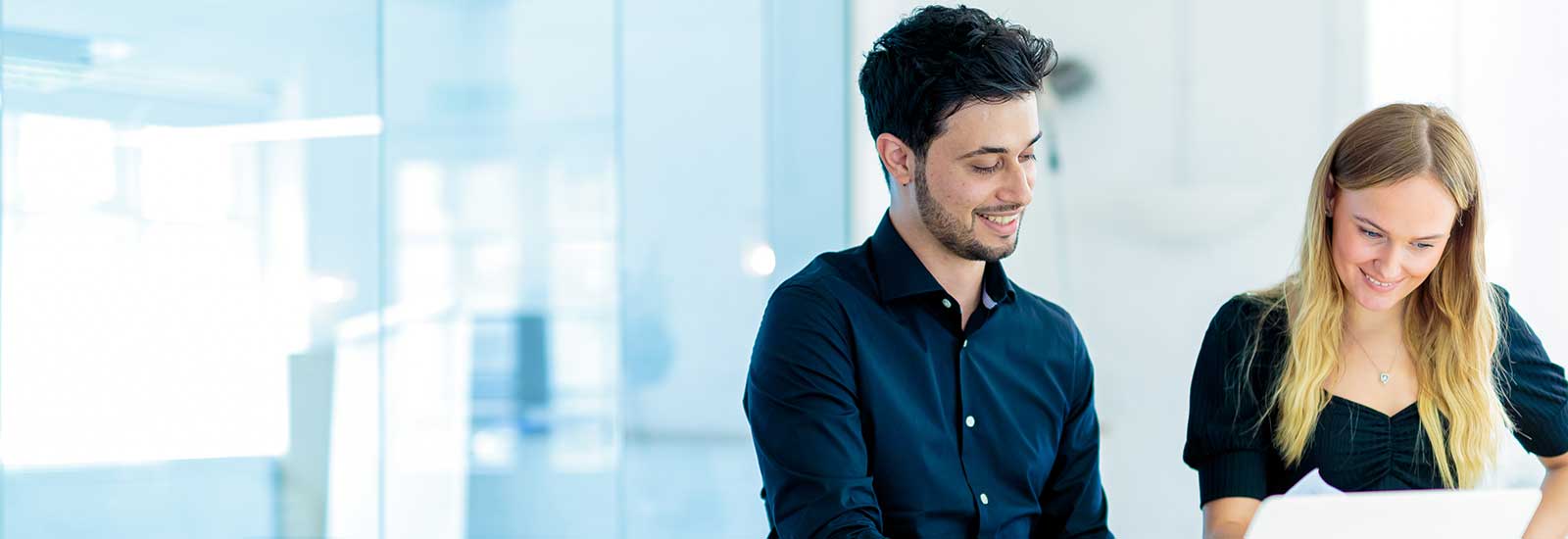 Two students working on a laptop