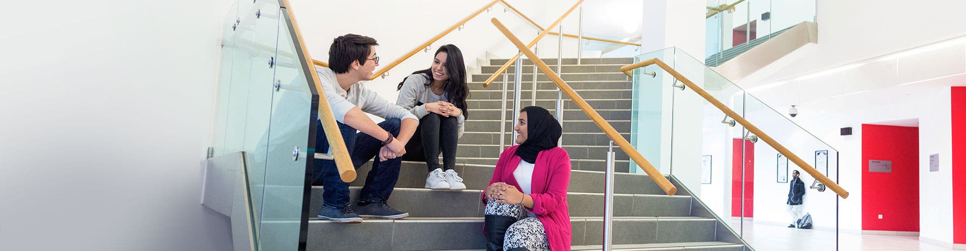 Students chatting on a staircase.