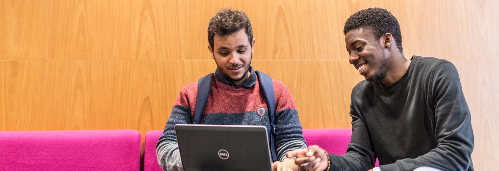 Two LJMU students using a laptop.