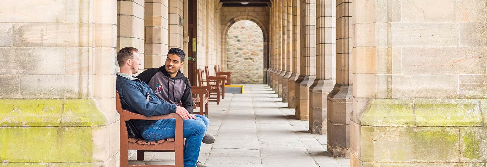 Students talking on bench on Aberdeen campus