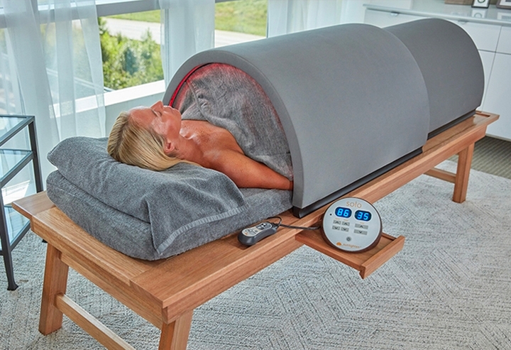 A woman lays in a Sunlighten Solo System