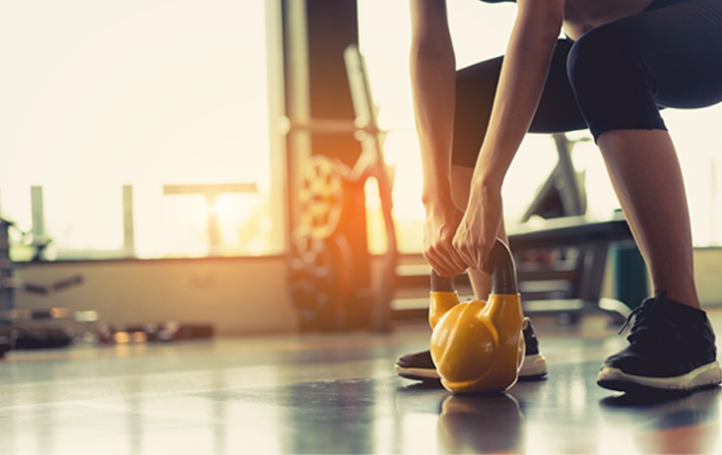 Woman lifting a kettle ball