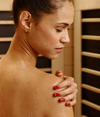 A woman sweating in a sauna