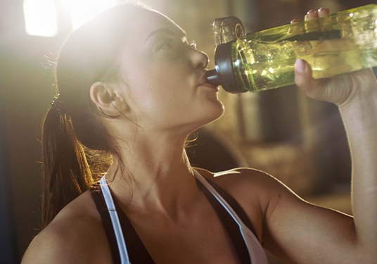 Woman drinking water out of a water bottle