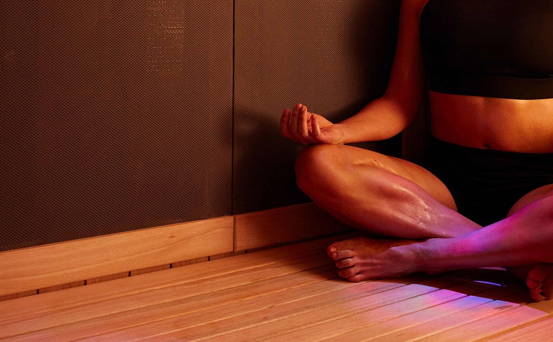 Woman meditating in a Sunlighten sauna