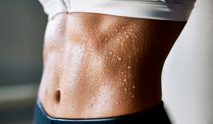 Athletic female's sweating stomach
