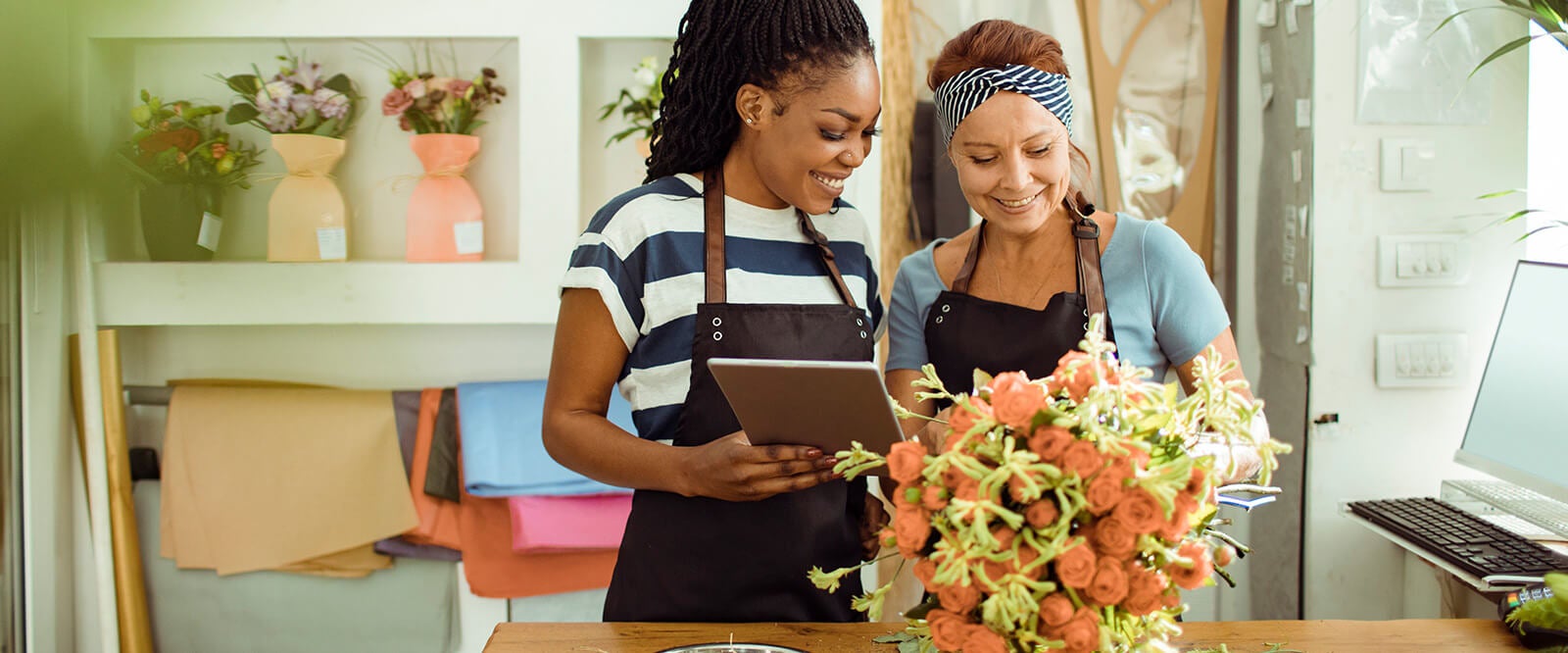 Two women florists looking at a bouquet.