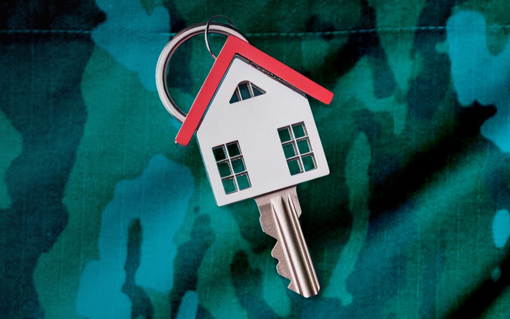 New home key with a house and a green camouflage background