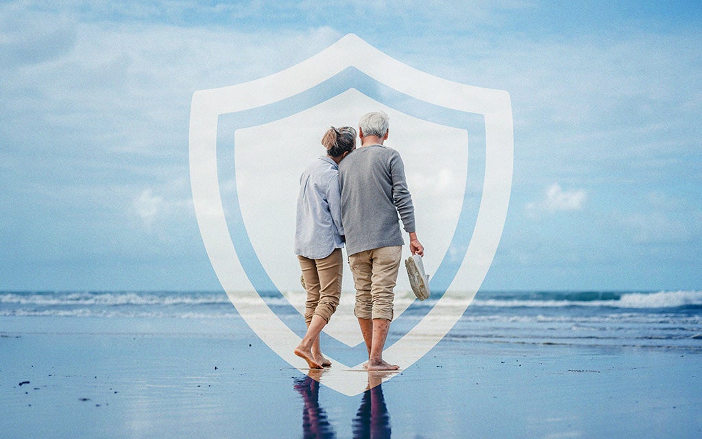 Elderly couple walking on the beach.