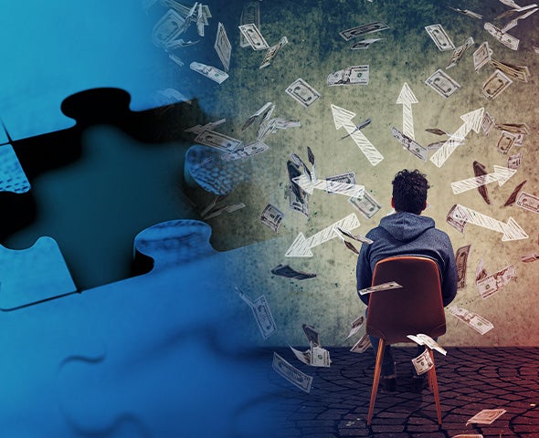 Male sitting in a chair with money floating around his head.