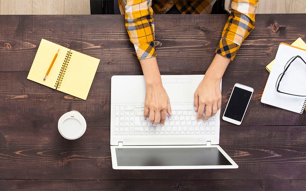 Person typing on keyboard