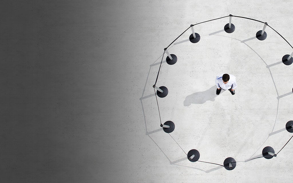 A man trapped in a circle of ropes to represent social distancing and mental health issues during the COVID-19 outbreak.