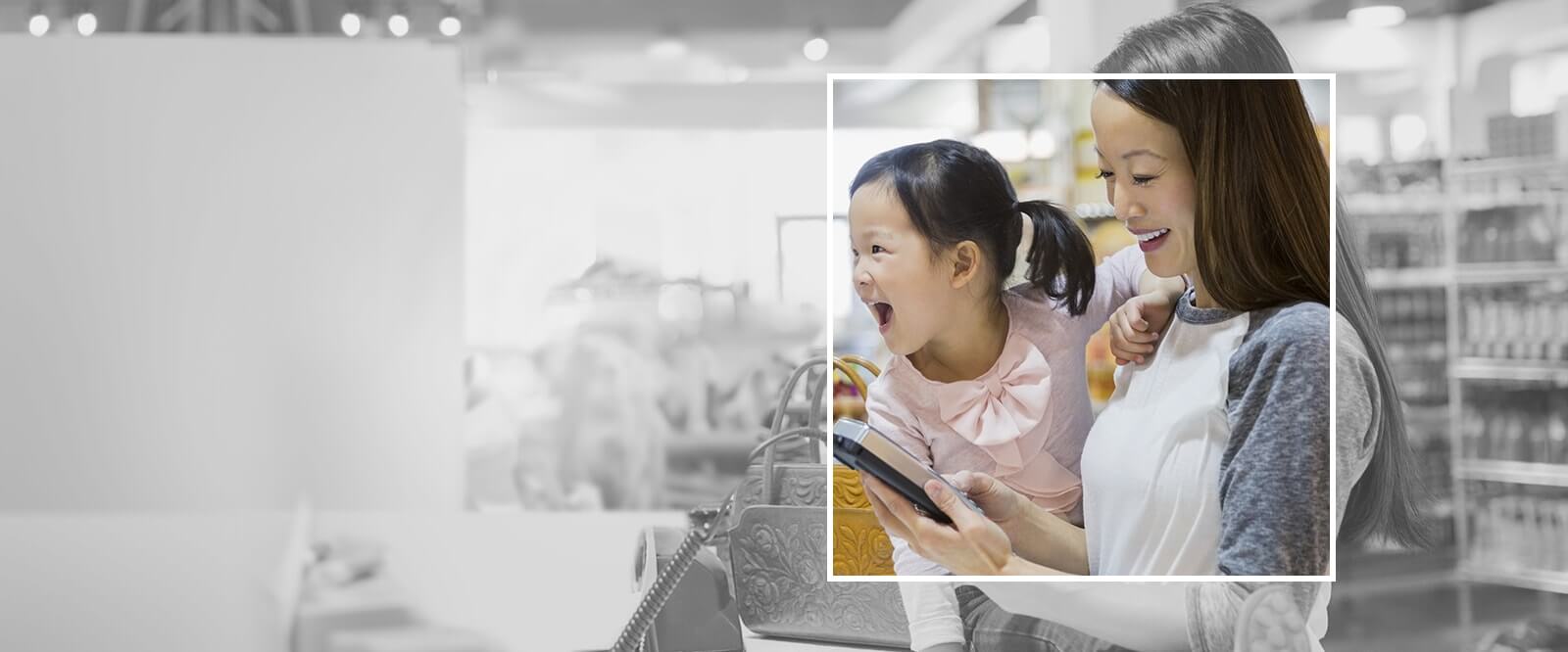 Banner image of a mom looking at a calculator with her child next to her.