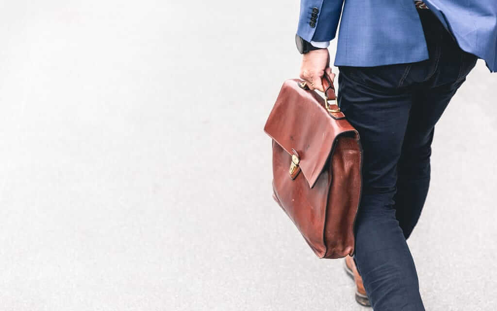 A man walking down the street with a briefcase