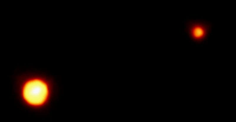 Pluto, then a planet, and its largest moon Charon, photographed by the Hubble Space Telescope, Feb. 21, 1994 (esahubble.org)