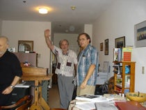 Photograph taken at an unspecified Gathering 4 Gardner meeting, probably in the 2010s, with Jeremiah Farrell at center with his arm raised. Jim Gardner, Martin Gardner’s son, is on the right (gathering4gardner.org)