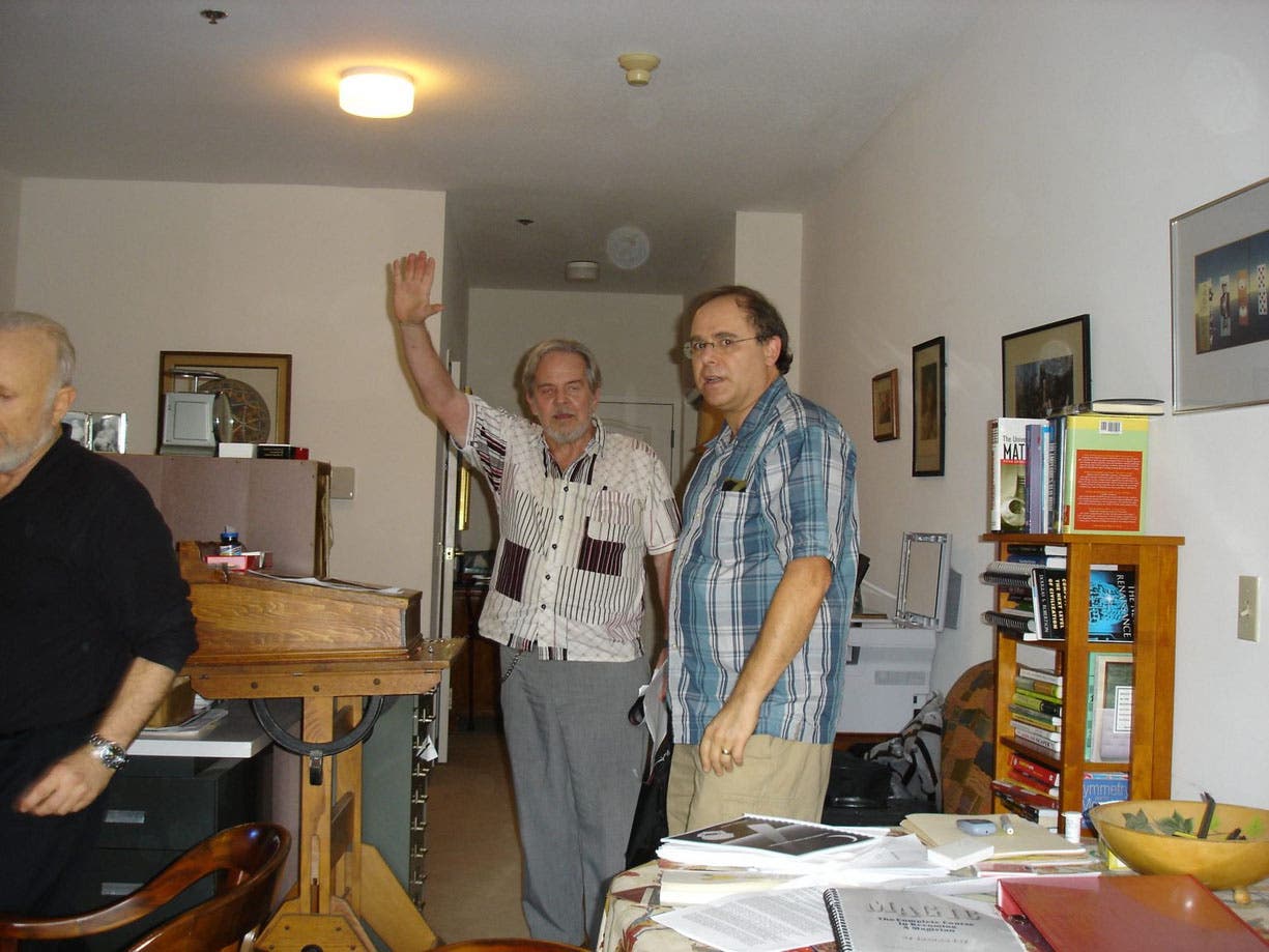 Photograph taken at an unspecified Gathering 4 Gardner meeting, probably in the 2010s, with Jeremiah Farrell at center with his arm raised. Jim Gardner, Martin Gardner’s son, is on the right (gathering4gardner.org)