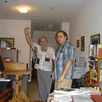 Photograph taken at an unspecified Gathering 4 Gardner meeting, probably in the 2010s, with Jeremiah Farrell at center with his arm raised. Jim Gardner, Martin Gardner’s son, is on the right (gathering4gardner.org)