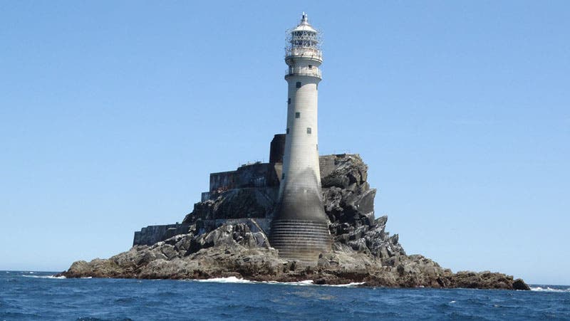Fastnet Rock Light, recent photograph, with the camera slightly off-level, but an excellent photo nevertheless; the base of the old lighthouse can be seen just behind the Douglass Tower, photo by Colin Prak (geograph.org.uk)