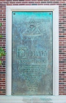 Bronze panel no. 1, based on the title page, Divina proportione, by Luca Pacioli, 1509, with one of Leonardo da Vinci's woodcut polyhedrons added at top; cast by Bruno Bearzi, 1965, north exterior annex wall, Linda Hall Library